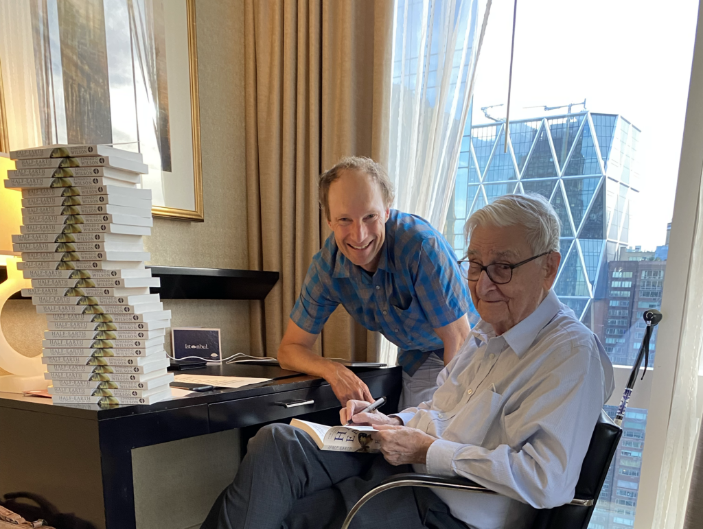 E.O. Wilson posing with a man while signing books.